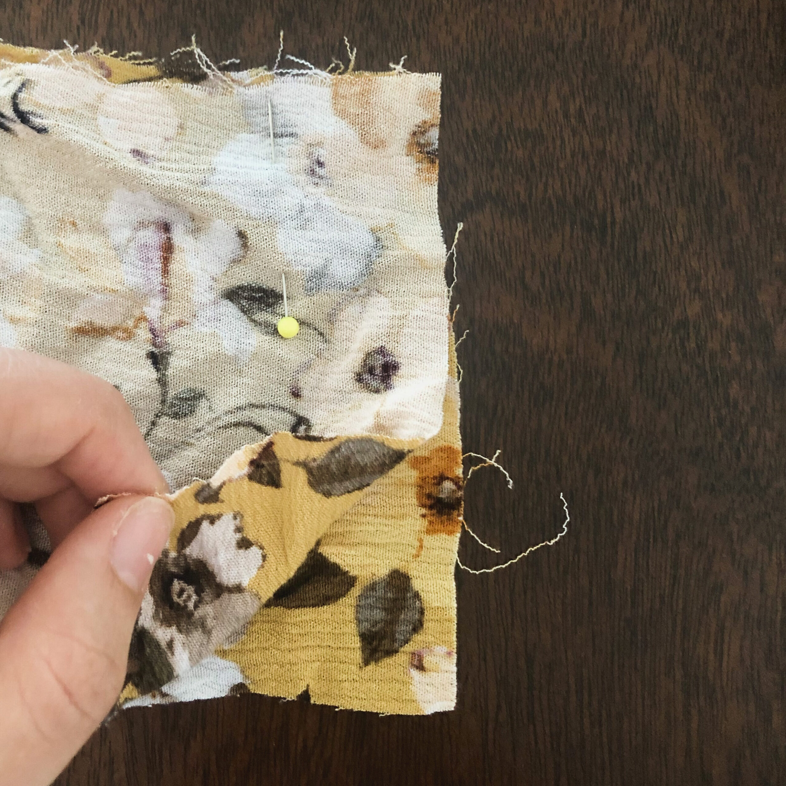 Line the 2 short ends of the fabric together.