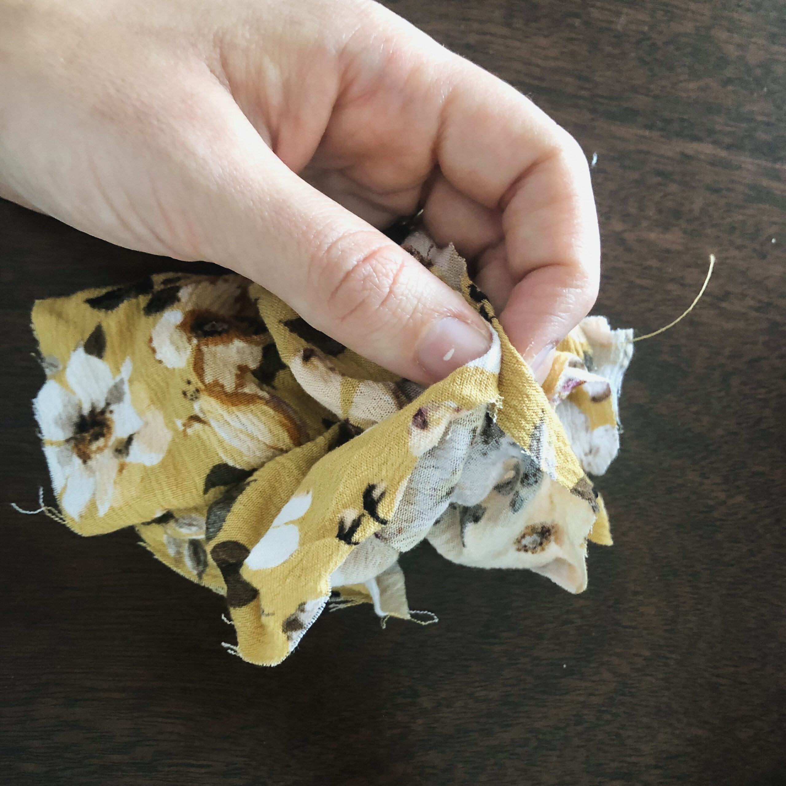 Fold the edges of the fabric together in order to pin the scrunchie